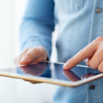 man blue shirt pressing touching ipad tablet 